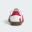 Pink and white heart-pattern low-top sneakers with gum soles.