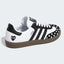 Black and white heart-pattern low-top sneaker, side view.