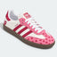 Pink and white heart-pattern low-top sneakers with gum soles.