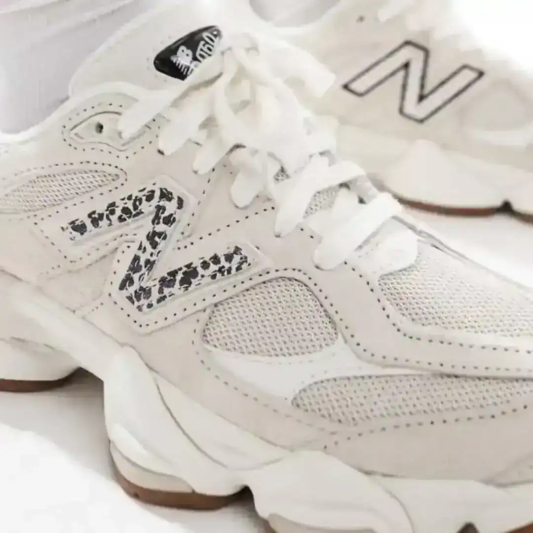 Close-up of the leopard-print side detail, laces and mesh panels on beige 9060 sneakers