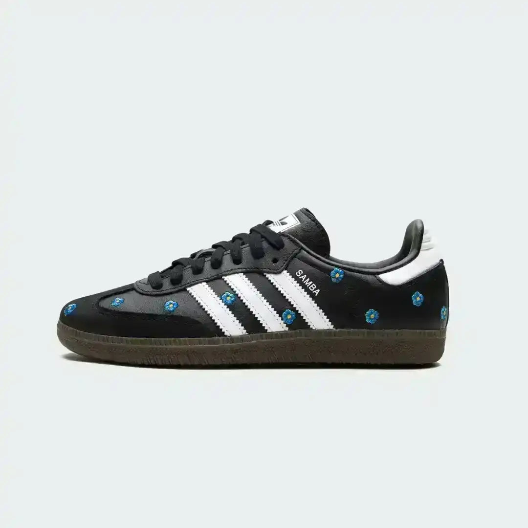 Adidas Samba crafted in black leather with blue floral embroidery across the upper, white stripes and a retro gum sole for a timeless look.