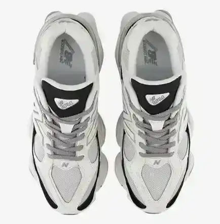 White and gray mesh-panel sneakers with black details and chunky soles.