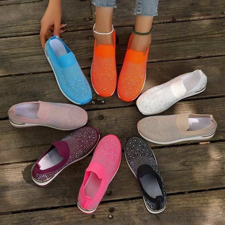 Front view of women's sparkly slip-on wedge sneakers showing breathable mesh upper and crystal details.