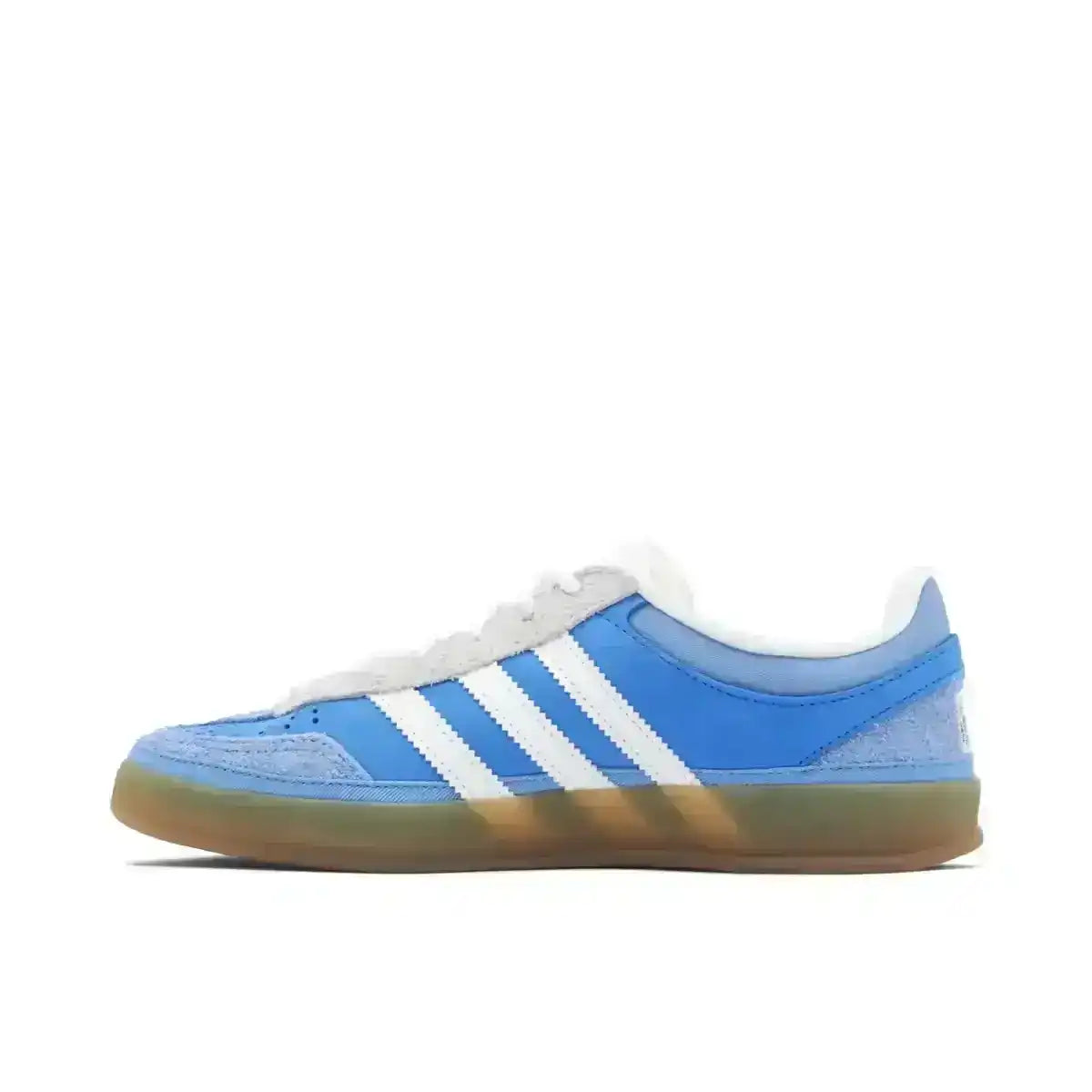 Blue and white three-stripe low-top sneakers with gum soles.