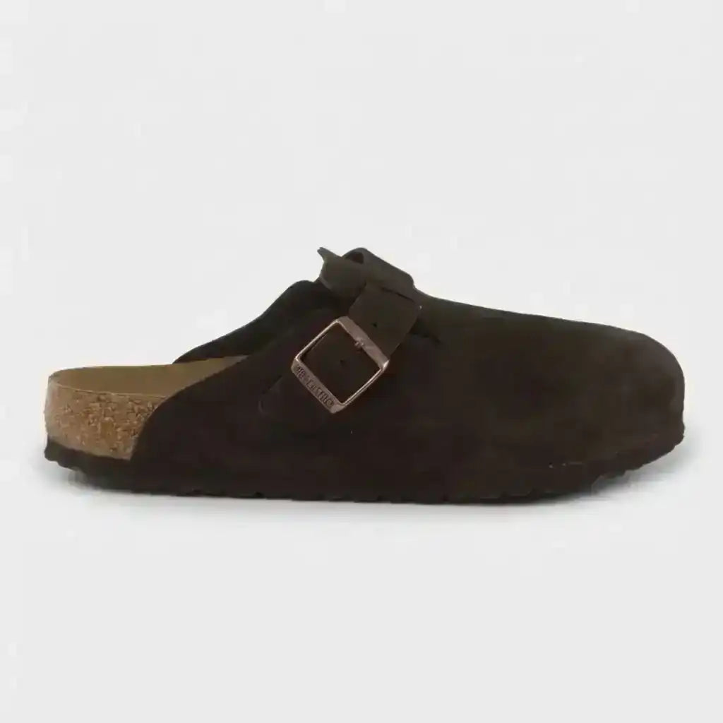 Dark brown closed-toe clogs with buckle straps.