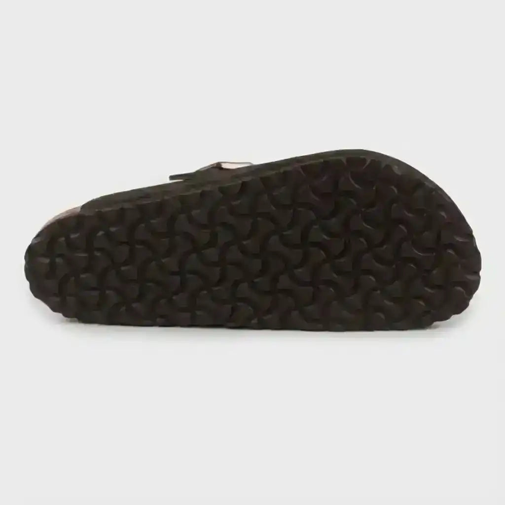 Dark clog outsole with a textured tread pattern, bottom view.