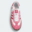 Pink heart-pattern sneaker with white laces, top view.