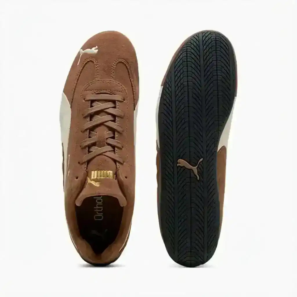 Brown low-profile lace-up sneakers with cream curved side stripes.