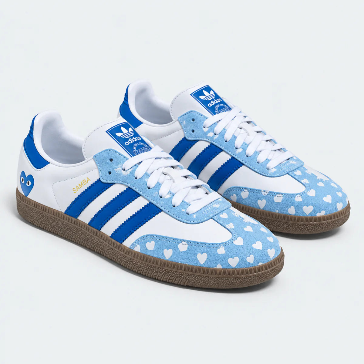 Blue and white heart-pattern low-top sneakers, pair view.