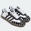 Black and white heart-pattern low-top sneakers, pair view.