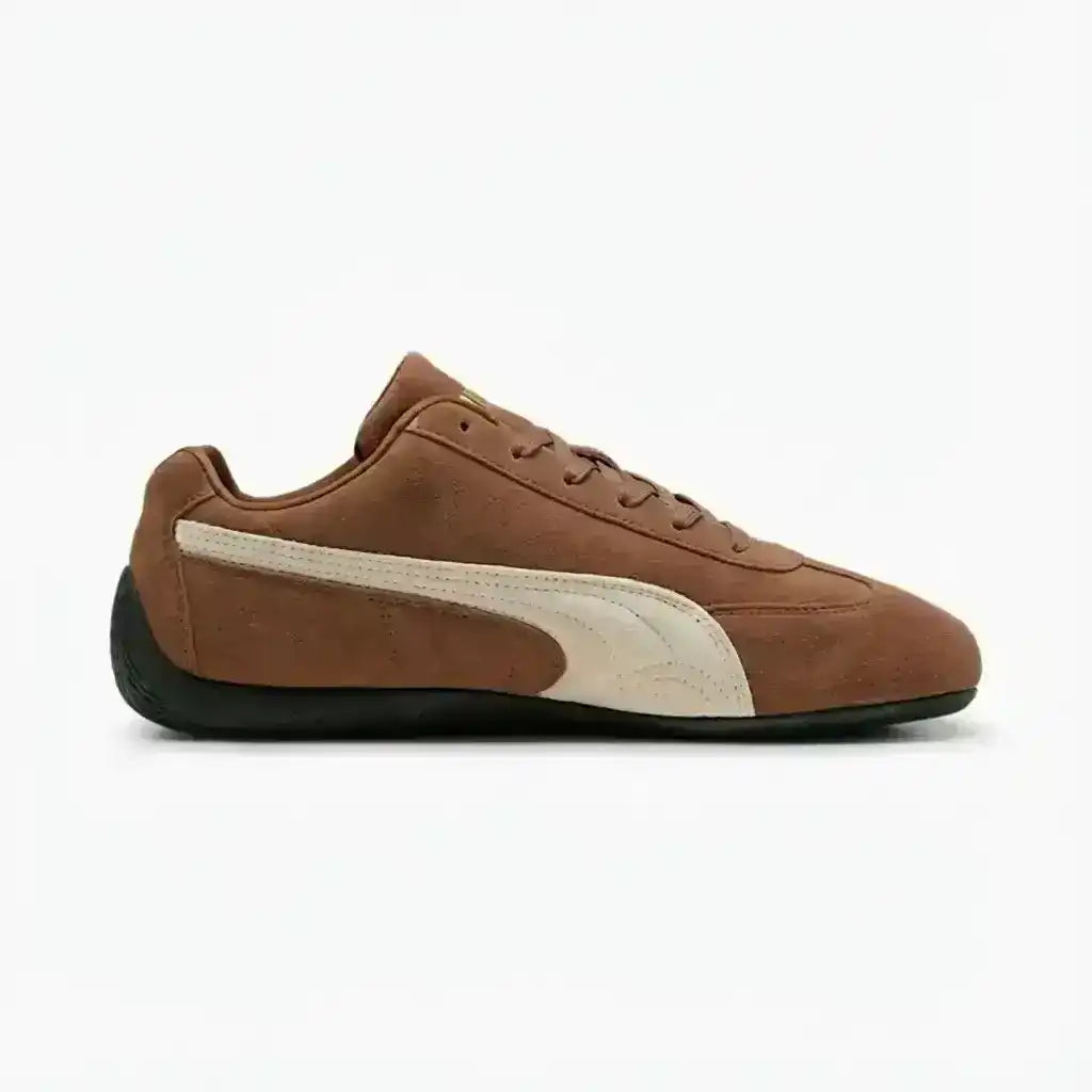 Brown low-profile lace-up sneakers with cream curved side stripes.