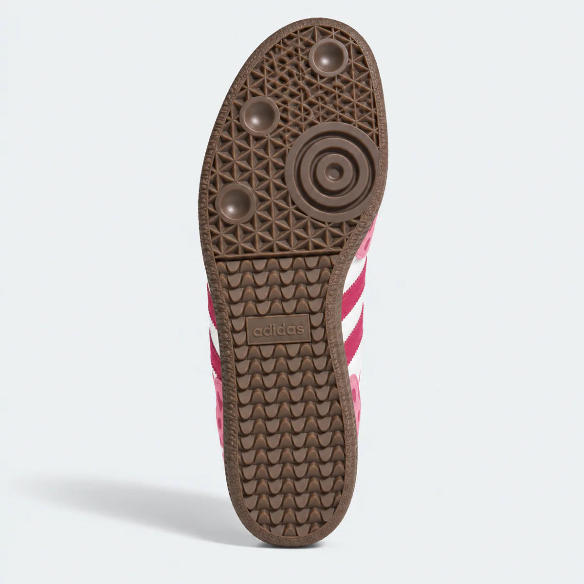 Brown sneaker outsole with circular tread, bottom view.