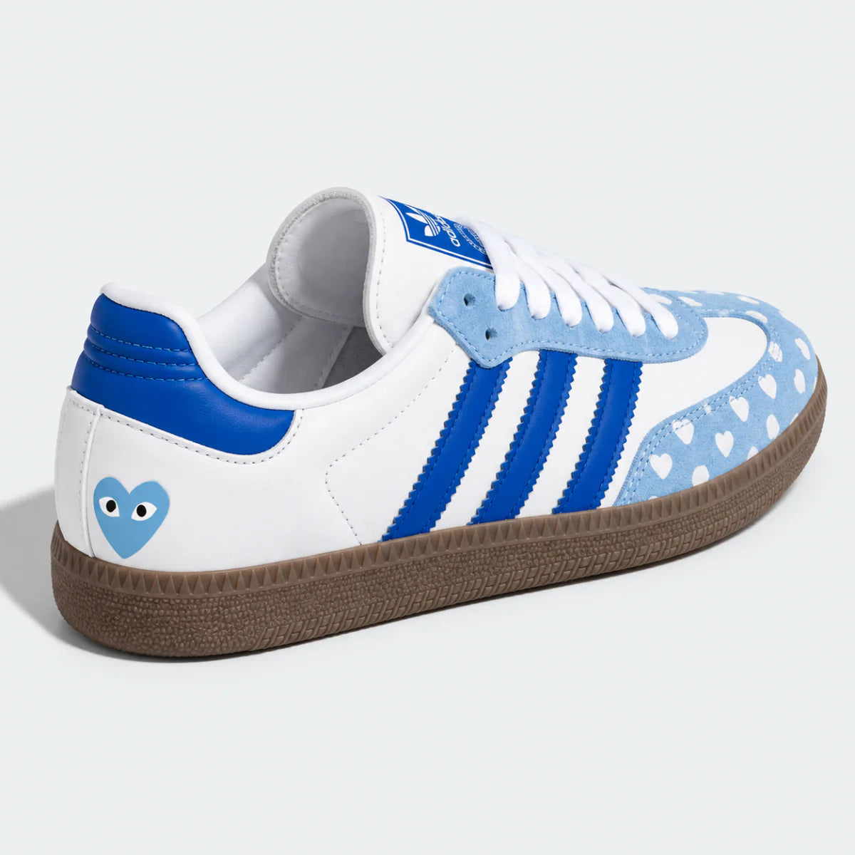 Blue and white heart-pattern low-top sneaker, side view.