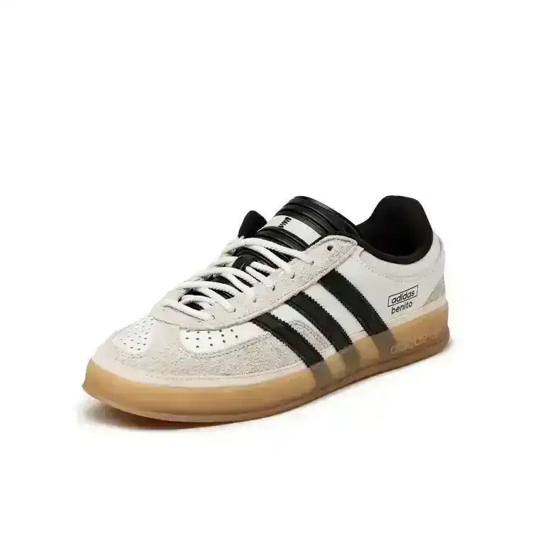 Cream and black three-stripe sneakers with gum soles.