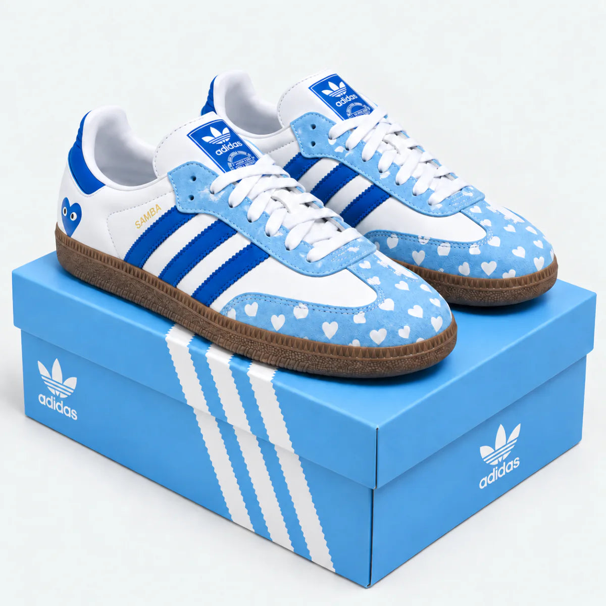 Blue and white heart-pattern sneakers displayed on a blue shoe box.