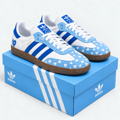 Blue and white heart-pattern sneakers displayed on a blue shoe box.