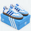 Blue and white heart-pattern sneakers displayed on a blue shoe box.