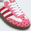 Pink and white heart-pattern low-top sneakers with gum soles.