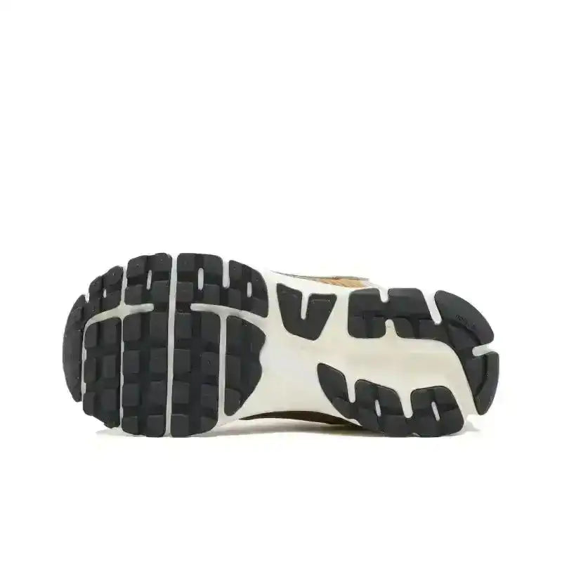 Black and white sneaker outsole with segmented tread, bottom view.