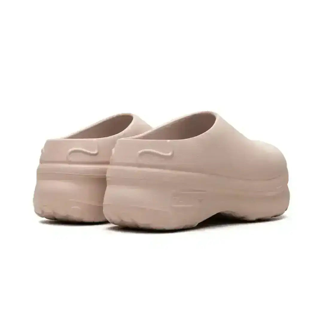 Molded closed-toe clogs with thick rounded soles.
