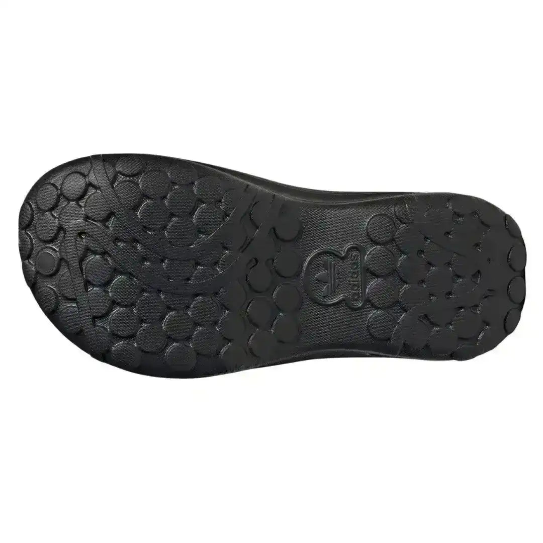 Black molded clog outsole with rounded tread shapes, bottom view.