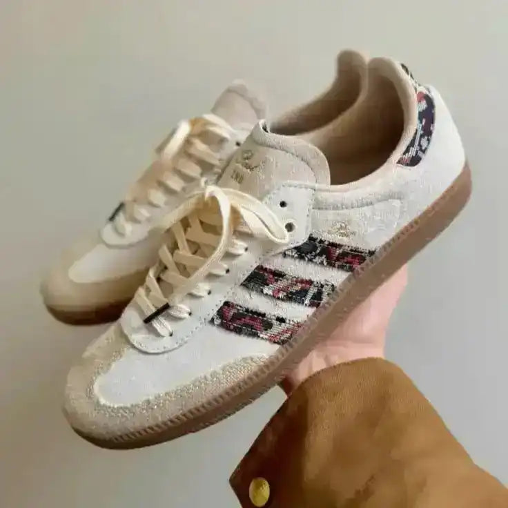 Cream low-top sneakers with multicolored patterned panels.