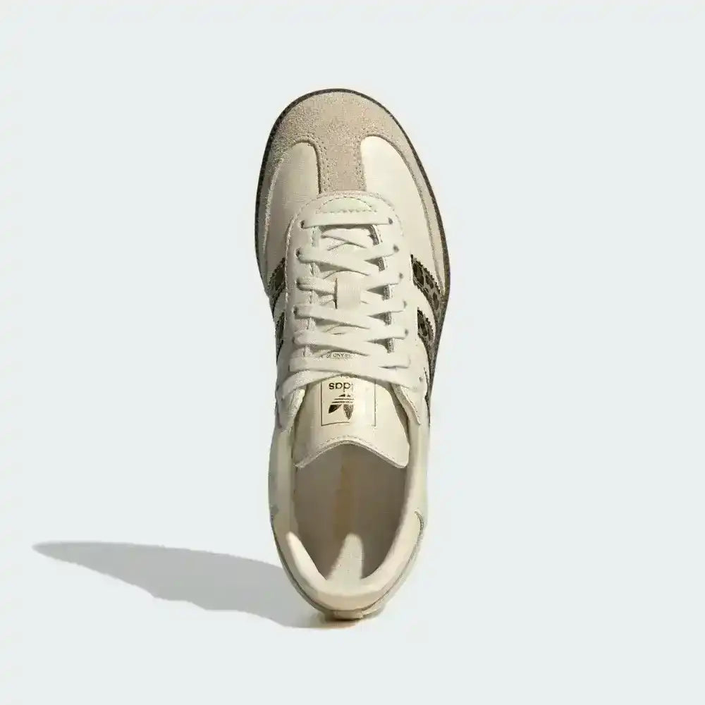 Cream low-top sneakers with leopard-pattern side stripes.
