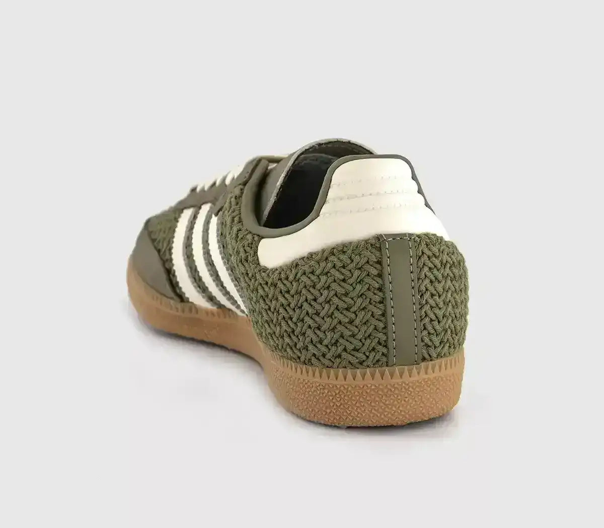 Olive green woven-texture sneakers with cream stripes and gum soles.