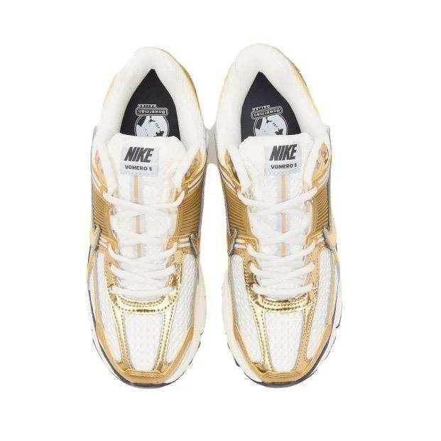 Gold-colored and cream sneakers with layered panels and chunky soles.