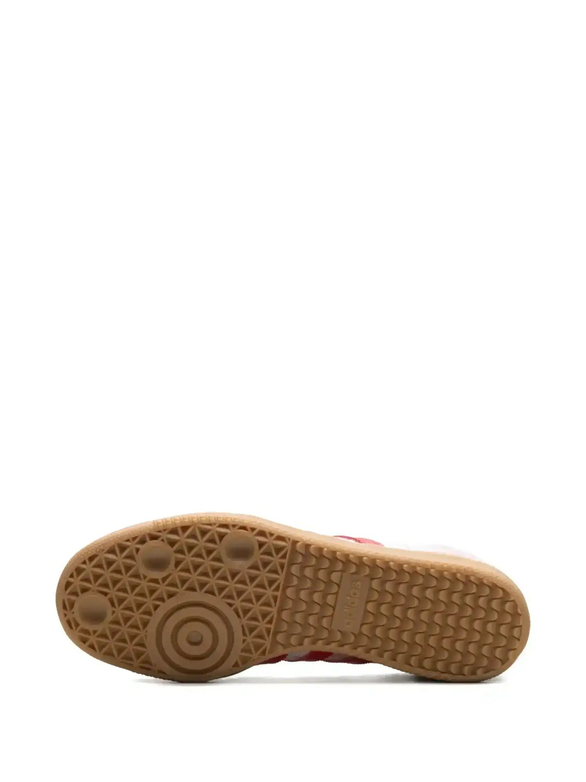 Brown sneaker outsole with circular tread, bottom view.