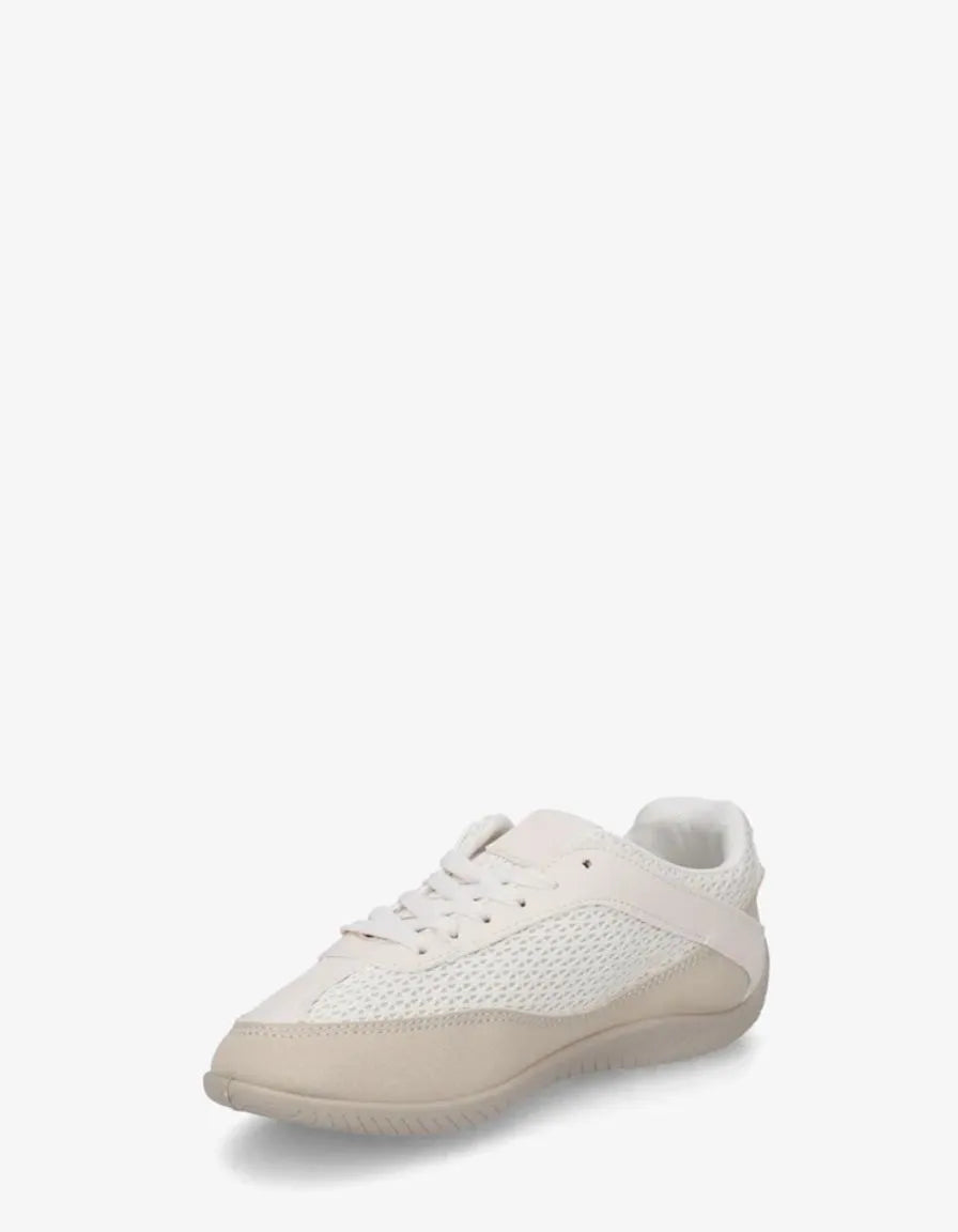 Off-white low-top lace-up sneakers with pale textured soles.