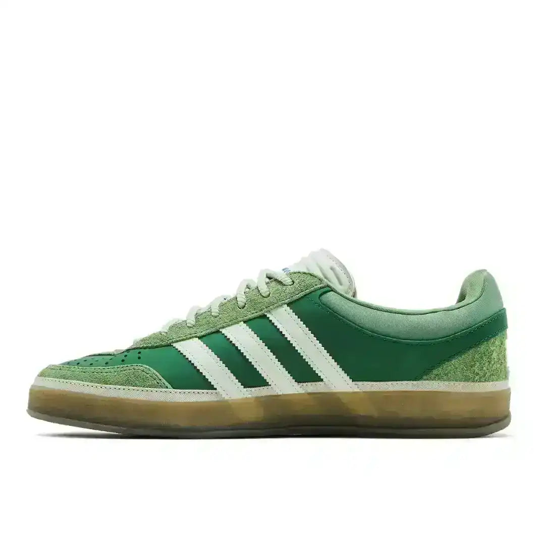 Green three-stripe low-top sneakers with gum soles.