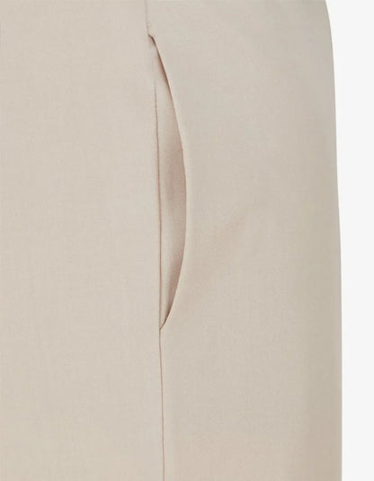 Close-up of a beige trouser side pocket and seam.
