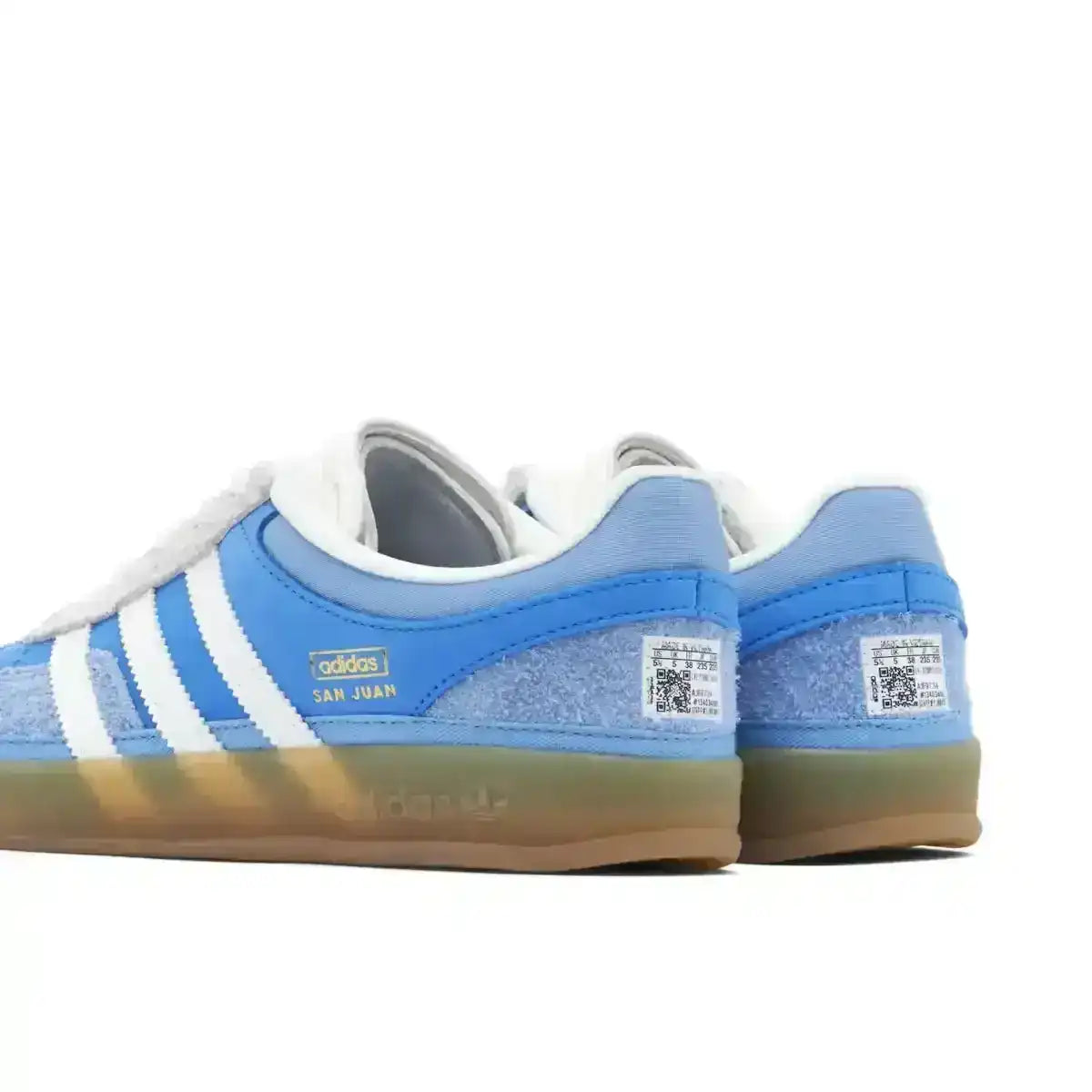 Blue and white three-stripe low-top sneakers with gum soles.