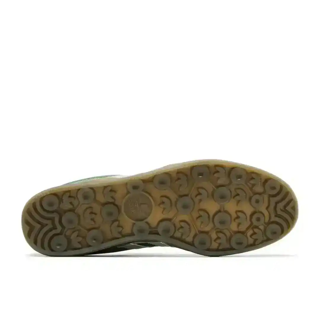 Gum-colored sneaker outsole with circular tread, bottom view.