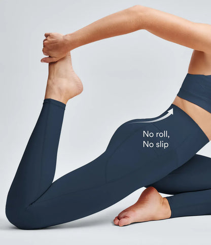 Person stretching a dark legging's waistband with both hands.