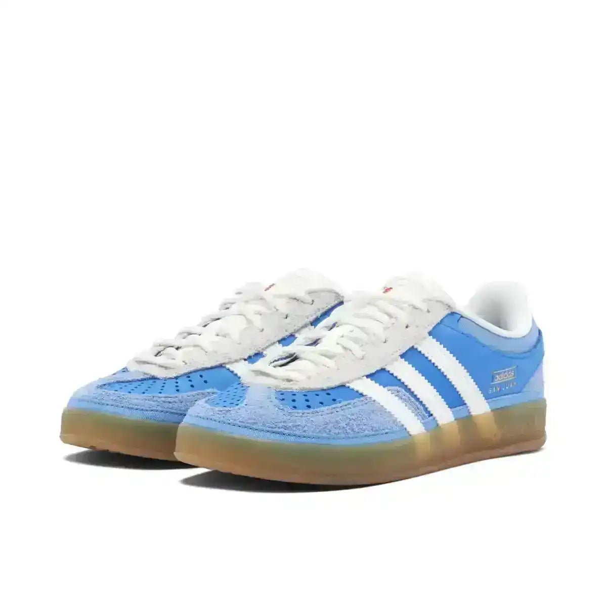 Blue and white three-stripe low-top sneakers with gum soles.