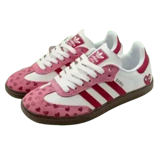 Pink and white low-top sneakers with small heart patterns.