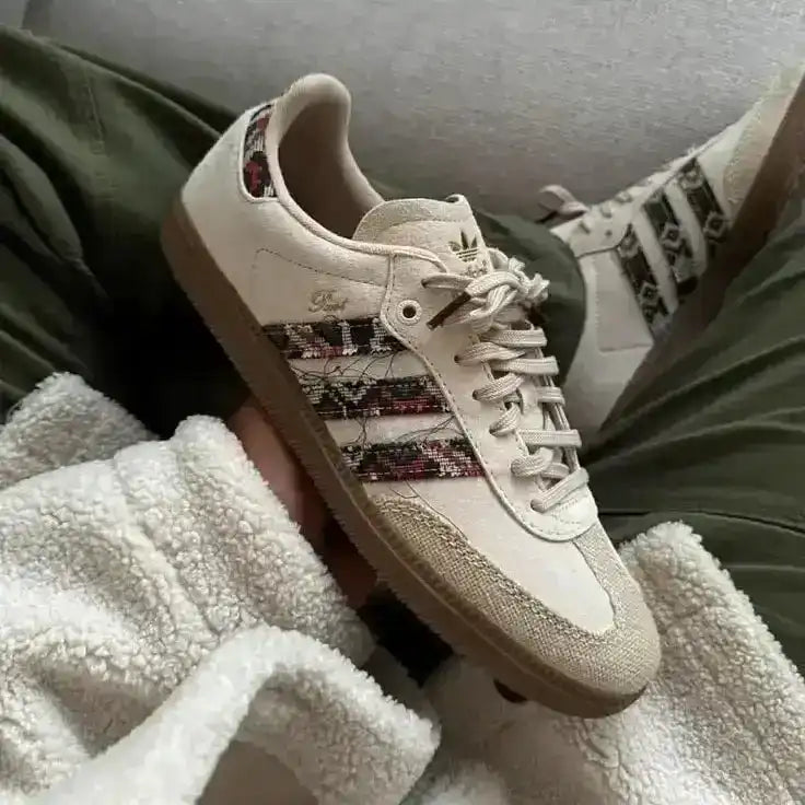 Cream low-top sneakers with multicolored patterned panels.