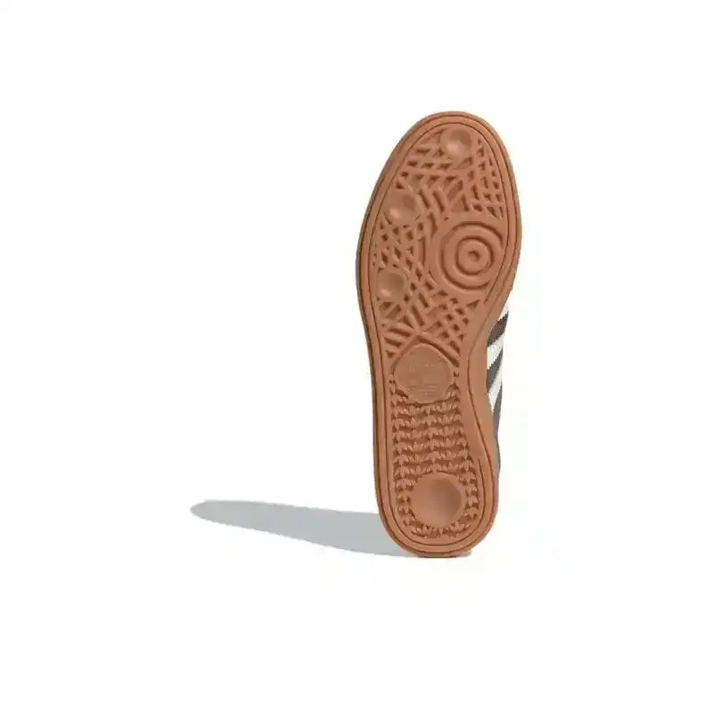 Gum-colored sneaker outsole with circular tread, bottom view.