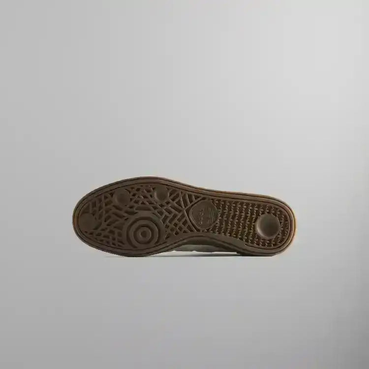 Brown sneaker outsole with circular tread, bottom view.