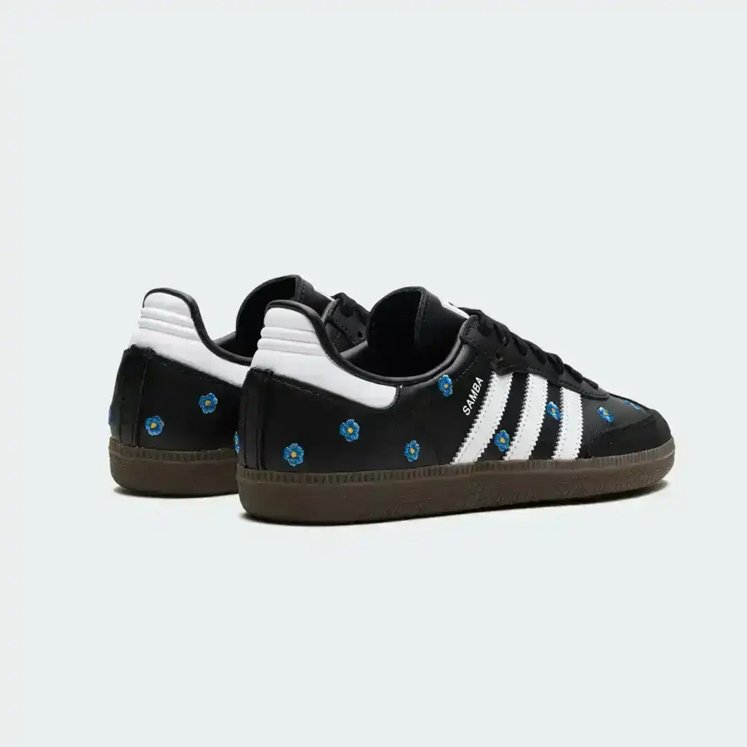Adidas Samba black leather sneakers with embroidered blue flowers, classic white stripes and a retro gum sole offering durability and timeless street style.