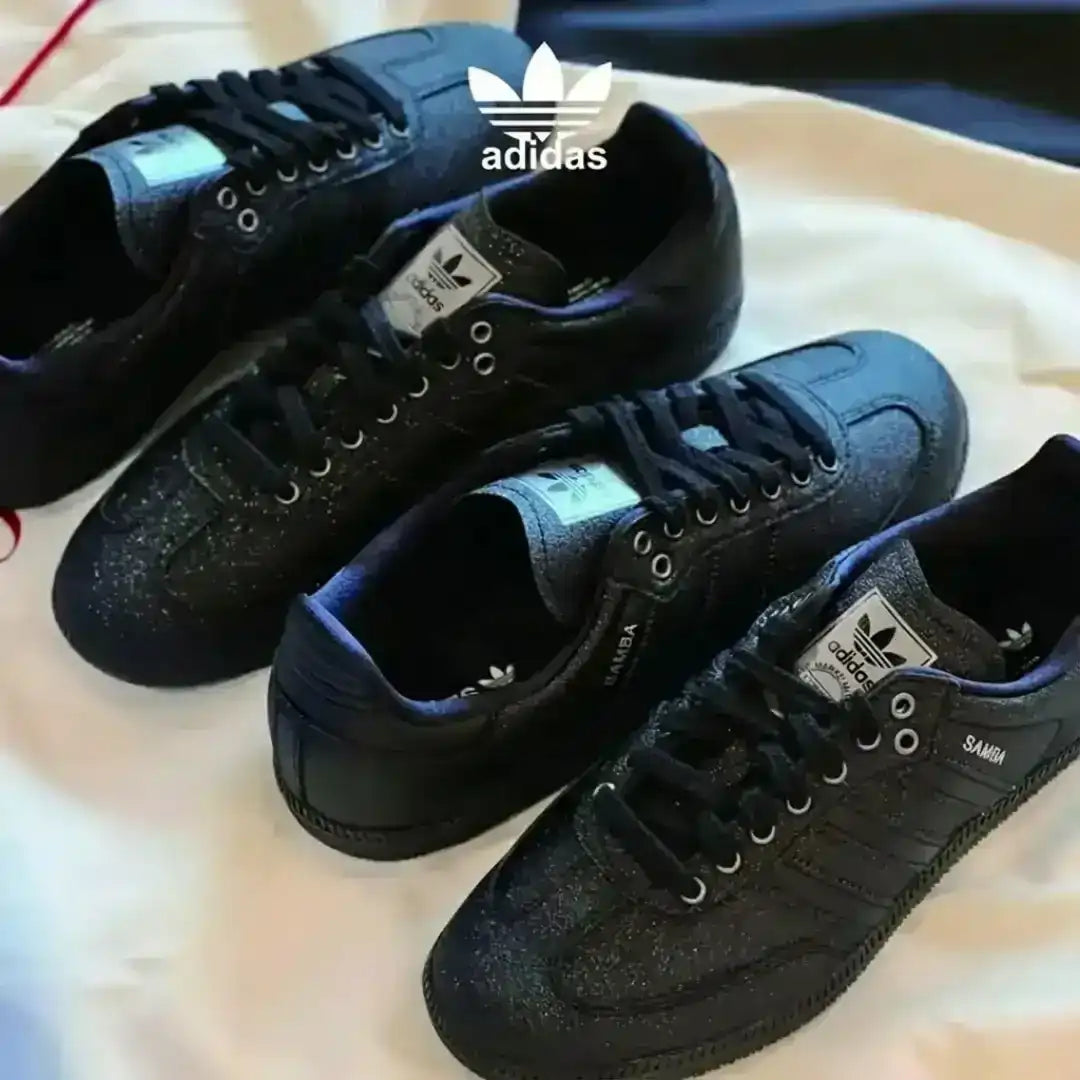 Adidas Samba lifestyle sneakers with black glitter leather, bold black laces and a dark gum sole, blending iconic style with a modern shine.