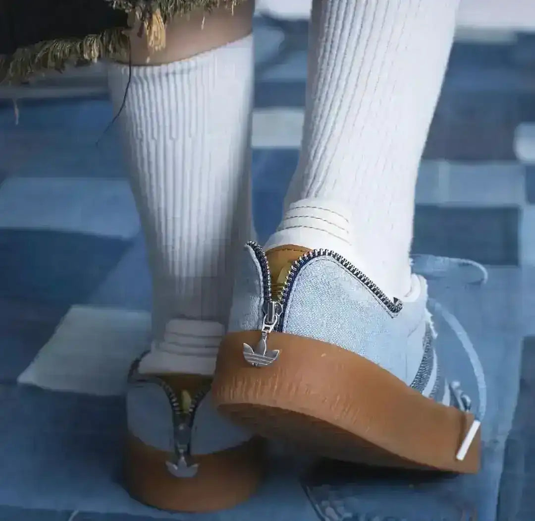 Blue denim-look low-top sneakers with pale laces and gum soles.