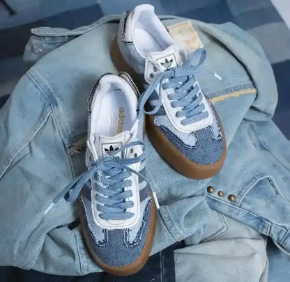 Blue denim-look low-top sneakers with pale laces and gum soles.
