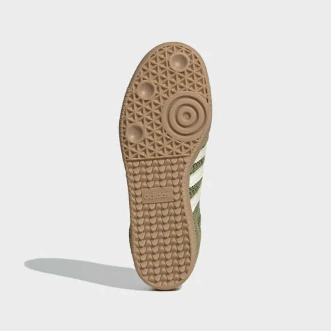 Gum-colored sneaker outsole with circular tread, bottom view.