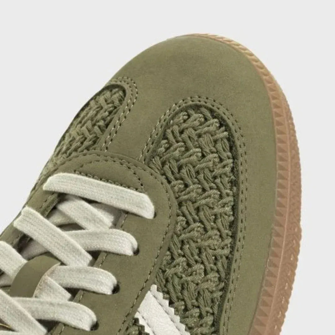 Close-up of olive woven-texture toe panel and cream laces.