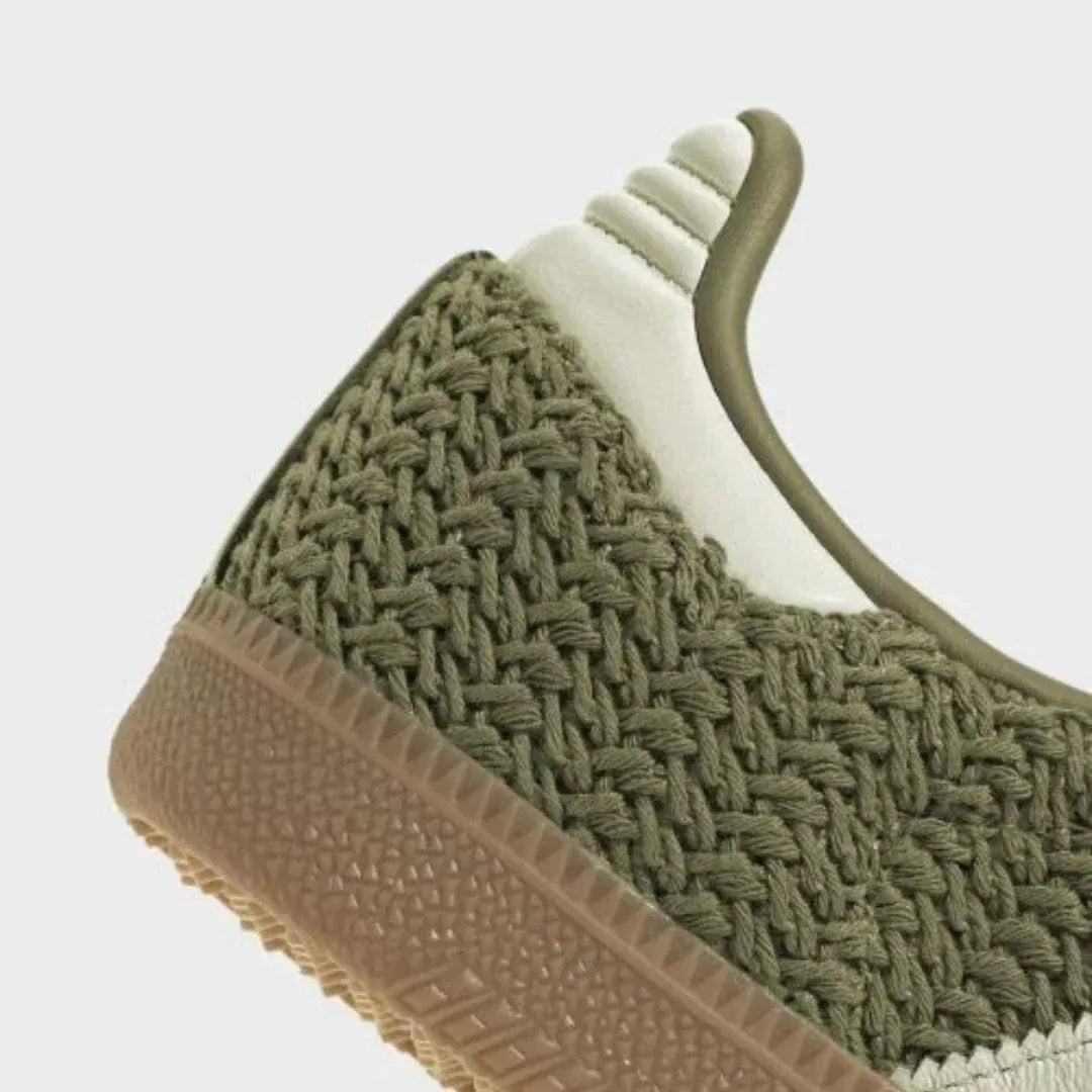 Close-up of olive woven heel panel and gum sole.