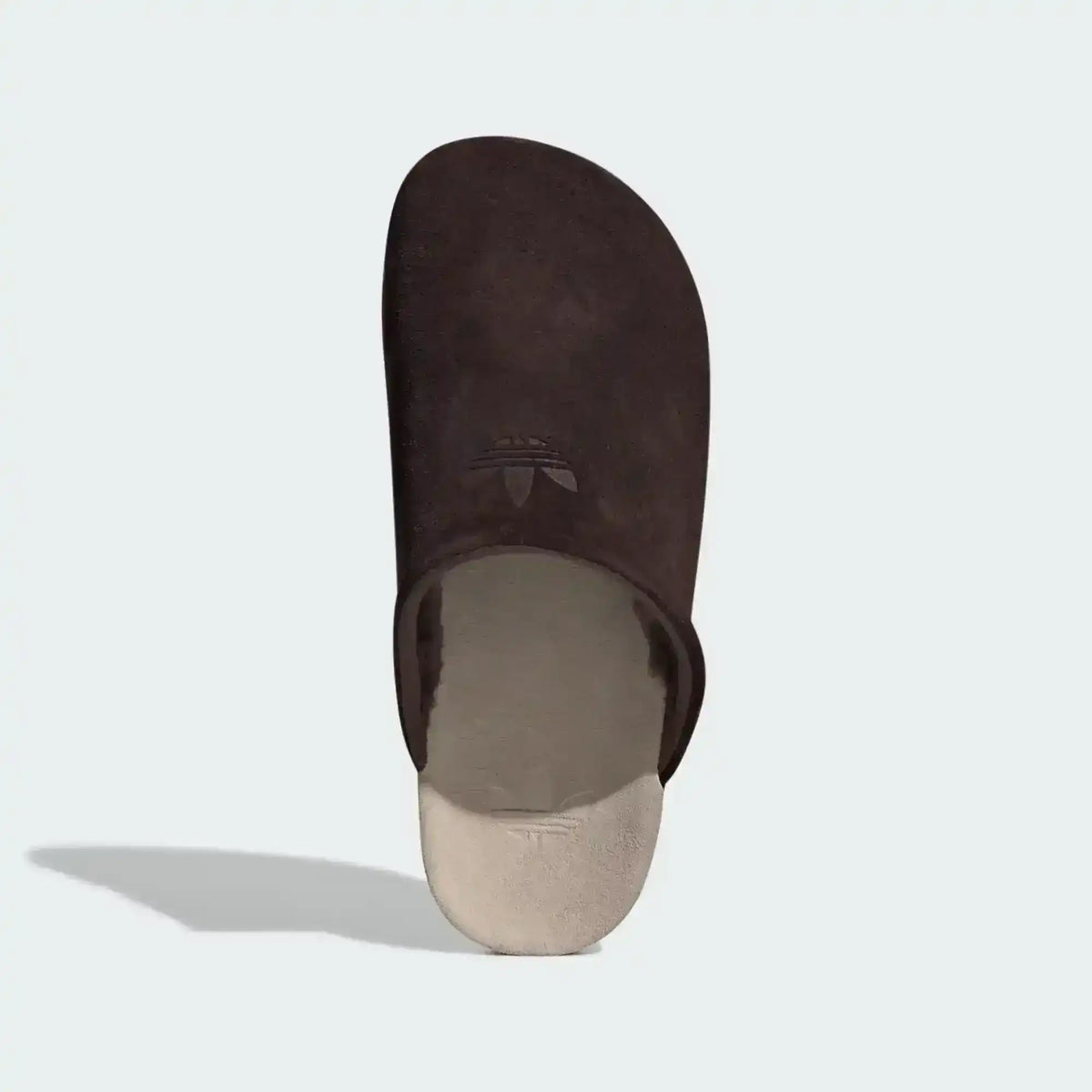 Closed-toe backless slide shoes with contrasting footbeds.