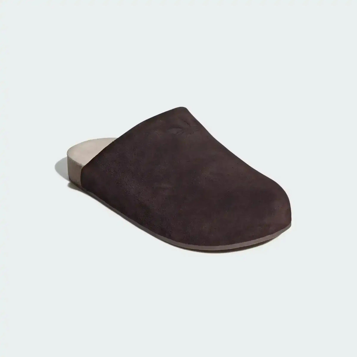 Closed-toe backless slide shoes with contrasting footbeds.